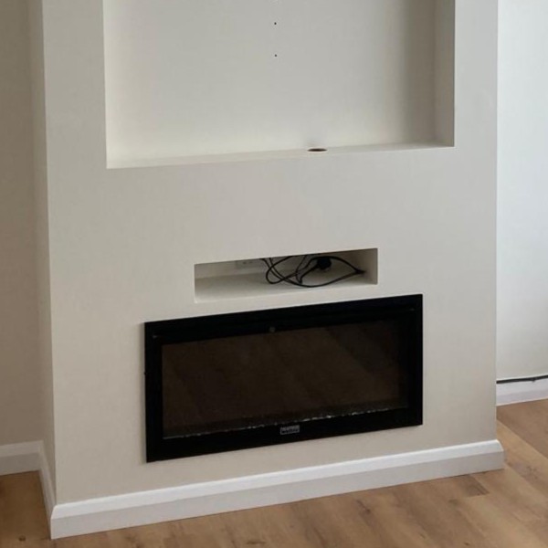 Finished plastered chimney breast with inset fire by VW Building Services